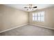 Neutral bedroom featuring a ceiling fan, window with shutters, and carpeted floor at 1584 Fernstone Nw Cir, Acworth, GA 30101