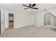 Bedroom featuring carpeted floor, ceiling fan, and a view into another room at 1584 Fernstone Nw Cir, Acworth, GA 30101