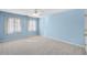 Blue bedroom featuring two windows with curtains and carpeted floor at 1584 Fernstone Nw Cir, Acworth, GA 30101