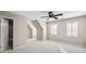 Bedroom featuring multiple windows, carpeted floor, ceiling fan, and sloped ceilings at 1584 Fernstone Nw Cir, Acworth, GA 30101