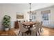 Elegant dining room with wood table, chandelier, wainscoting and large window at 1584 Fernstone Nw Cir, Acworth, GA 30101