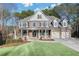 Charming two-story home with stone and brick facade, two car garage, and lush front lawn at 1584 Fernstone Nw Cir, Acworth, GA 30101