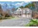 Beautiful two-story home featuring a manicured lawn and long driveway at 1584 Fernstone Nw Cir, Acworth, GA 30101