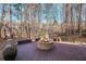Outdoor fire pit area with stone benches surrounded by trees, perfect for entertaining at 1584 Fernstone Nw Cir, Acworth, GA 30101