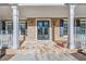 Welcoming front porch with stone accents, white columns and a double door entry at 1584 Fernstone Nw Cir, Acworth, GA 30101