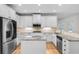 Modern kitchen with white cabinets, granite counters, and stainless steel appliances at 1584 Fernstone Nw Cir, Acworth, GA 30101