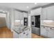 Well lit kitchen showcases white cabinets, stainless steel appliances, and an island with granite countertop at 1584 Fernstone Nw Cir, Acworth, GA 30101
