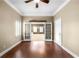Bright living room with hardwood floors, ceiling fan, and french doors to another room at 1584 Fernstone Nw Cir, Acworth, GA 30101
