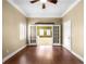Bright living room with hardwood floors, ceiling fan, and french doors to another room at 1584 Fernstone Nw Cir, Acworth, GA 30101
