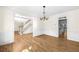Open-concept living room with hardwood floors, chandelier, and seamless flow to other rooms at 1584 Fernstone Nw Cir, Acworth, GA 30101