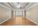 Large primary bedroom showcases hardwood floors, tray ceiling, and lots of natural light at 1584 Fernstone Nw Cir, Acworth, GA 30101