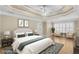 Staged primary bedroom with tray ceiling, hardwood floors, and ample natural light at 1584 Fernstone Nw Cir, Acworth, GA 30101