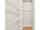 Walk-in pantry with white wire shelving and hardwood floors offer ample storage space at 1584 Fernstone Nw Cir, Acworth, GA 30101