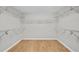 Spacious walk-in closet with hardwood floors and multiple wire shelves for storage at 1584 Fernstone Nw Cir, Acworth, GA 30101