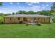 A spacious backyard with a well-manicured lawn and brick home exterior at 1652 Detroit Nw Ave, Atlanta, GA 30314