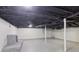 Finished basement featuring white painted walls and floor, with dark-painted exposed ceiling at 1652 Detroit Nw Ave, Atlanta, GA 30314