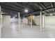 Spacious basement with open ceiling, support beams, and potential for customization at 1652 Detroit Nw Ave, Atlanta, GA 30314