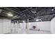 Finished basement space with a fireplace, white painted walls, and an exposed ceiling at 1652 Detroit Nw Ave, Atlanta, GA 30314