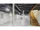 Basement with open ceiling, support beams, and stairs leading to upper level at 1652 Detroit Nw Ave, Atlanta, GA 30314