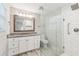 Modern bathroom with a glass shower door, vanity with granite counters and white cabinets at 1652 Detroit Nw Ave, Atlanta, GA 30314