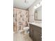 Bathroom with tiled floor, modern vanity, and shower with decorative curtain at 1652 Detroit Nw Ave, Atlanta, GA 30314