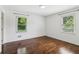 Well-lit bedroom boasts hardwood floors, white walls, and two windows at 1652 Detroit Nw Ave, Atlanta, GA 30314