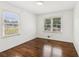 Bright bedroom featuring hardwood floors, white walls, and natural light from two windows at 1652 Detroit Nw Ave, Atlanta, GA 30314