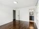 Bedroom with hardwood floors leads to bathroom with modern gray vanity at 1652 Detroit Nw Ave, Atlanta, GA 30314