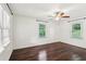 Bright bedroom with hardwood floors, modern lighting, and natural light from two windows at 1652 Detroit Nw Ave, Atlanta, GA 30314