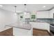Modern kitchen featuring stainless appliances, granite countertops and backsplash, island, and pendant lighting at 1652 Detroit Nw Ave, Atlanta, GA 30314