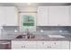 Granite countertop and backsplash compliment white cabinets at 1652 Detroit Nw Ave, Atlanta, GA 30314