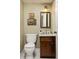 Cozy half-bathroom features a wood vanity with marble top, classic fixtures, decorative art and neutral paint at 266 Adair St, Decatur, GA 30030
