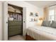 Bedroom with a built-in dresser inside a closet and shelves along the wall for storing personal items at 266 Adair St, Decatur, GA 30030