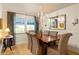 Well-lit dining room featuring hardwood floors, a chandelier, and traditional furnishings, next to large windows at 266 Adair St, Decatur, GA 30030