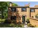 Charming brick townhome featuring black shutters, an inviting front door and a manicured lawn at 266 Adair St, Decatur, GA 30030