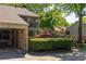 Exterior view of a two-story home with a brick wall, green hedges, and well-maintained landscaping at 266 Adair St, Decatur, GA 30030
