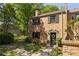 Brick townhouse featuring manicured front lawn with trimmed hedges and colorful flower pots around the front door at 266 Adair St, Decatur, GA 30030