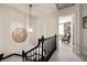 Hallway with hanging light fixture and view into a cozy room with built in shelves at 266 Adair St, Decatur, GA 30030