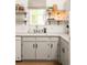 Modern kitchen features white cabinets, updated countertops, and minimalist decor, next to large windows at 266 Adair St, Decatur, GA 30030