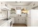 Bright kitchen featuring white cabinets, stainless steel appliances, and open shelving at 266 Adair St, Decatur, GA 30030
