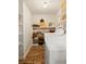 Functional laundry area with brick flooring and ample shelving for storage at 266 Adair St, Decatur, GA 30030
