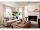 Bright living room featuring neutral tones, a fireplace, and large windows at 266 Adair St, Decatur, GA 30030