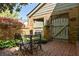 Brick patio with a table, four chairs, wooden fence, and lush greenery at 266 Adair St, Decatur, GA 30030