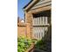 Charming brick patio with wooden fence, lush greenery, and garden lighting at 266 Adair St, Decatur, GA 30030