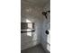 Bathroom shower featuring marble-look tiled walls, mosaic floors, and a built-in niche at 3065 Ashly Pines Dr, Snellville, GA 30078