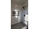 Bathroom shower featuring marble-look tiled walls, mosaic floors, and a built-in niche at 3065 Ashly Pines Dr, Snellville, GA 30078