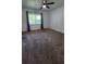 Bright bedroom with ceiling fan, carpet and large window allowing ample natural light at 3065 Ashly Pines Dr, Snellville, GA 30078