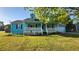Charming blue cottage-style home with a welcoming front porch and landscaped lawn at 3065 Ashly Pines Dr, Snellville, GA 30078