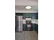 Modern kitchen featuring dark green cabinets, updated appliances, and light countertops at 3065 Ashly Pines Dr, Snellville, GA 30078