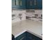 Close up on stylish kitchen countertop and cabinets, complete with wooden backsplash at 3065 Ashly Pines Dr, Snellville, GA 30078